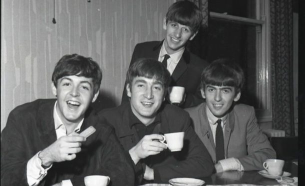 The Beatles enjoying a cup of tea in 1963.