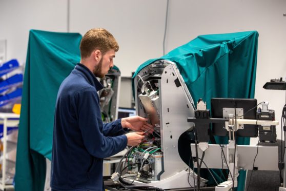 A worker at Optos' manufacturing facility in Dunfermline.