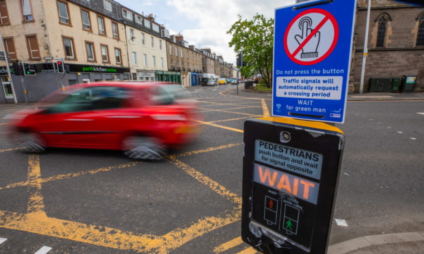 Do Not Touch signs were placed at pedestrian crossings across Perth and Kinross at the end of lockdown