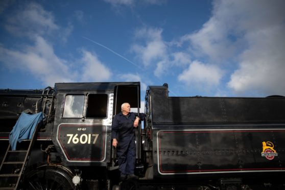 Driver Dave Pallett, who has volunteered on the Mid Hants Railway for over 25 years, looks out of the cab of the  British Railways Standard Class 4MT steam locomotive 76017 as he poses for a photograph at Ropley station, ahead of this weekend's Autumn Steam Gala on the Mid Hants Railway's Watercress Line. PA Photo. Picture date: Thursday October 15, 2020. Photo credit should read: Andrew Matthews/PA Wire