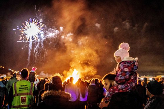 Molly Arthur (2) sits on Dad, Mark's shoulders watching the fireworks display with excitement at Burntisland last year.