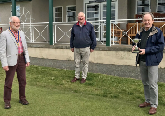 President Hamish Tait, left, congratulating winner Alan Constable with tournament director Angus Mitchell looking on.