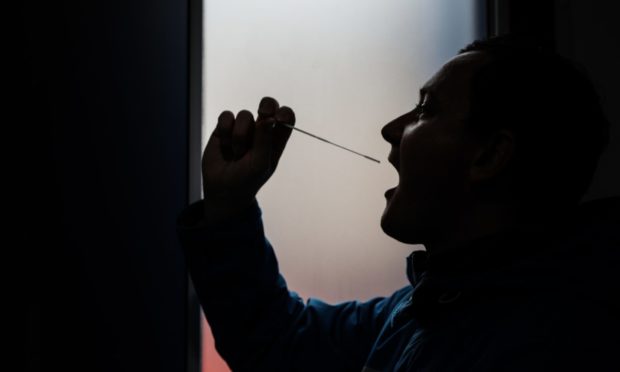 A man takes a coronavirus test in Dundee.