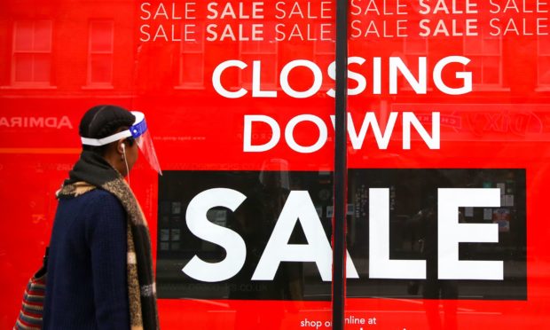 A closing down sign at a Peacocks store