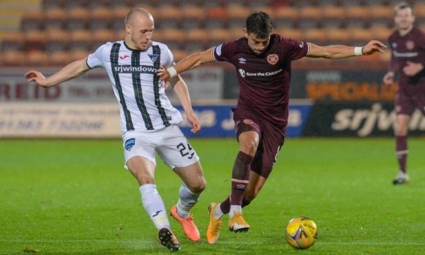 Dunfermline midfielder Kerr McInroy hassles Hearts' Olly Lee.