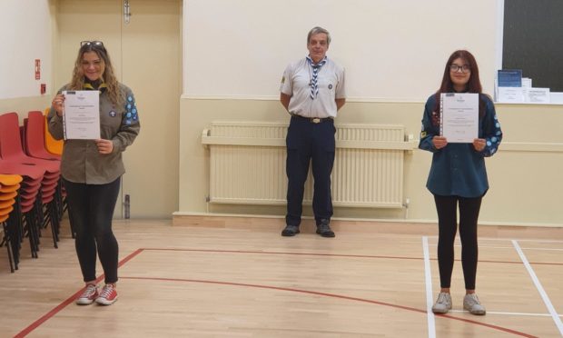 Explorer Scout Alicia Thomson (left) with Scout Maddison MacPherson (right) with District Commissioner for Kirkcaldy Scouts District Richard Cook