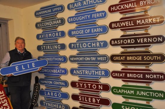 Auctioneer Neil Booth is pictured with some of the signs.