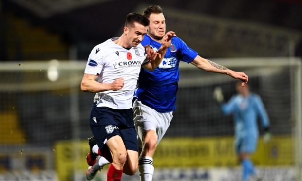 Dundee's Cammy Kerr battles with Mitch Megginson of Cove Rangers at Dens Park.