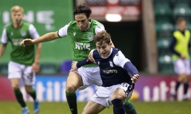 Dundee's Fin Robertson (right) holds off Joe Newell during the Betfred Cup match on Sunday.