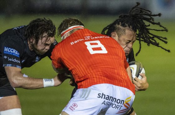 Glasgow Warriors' Ryan Wilson and TJ Ioane (right) try to stop Muster's Gavin Coombes.