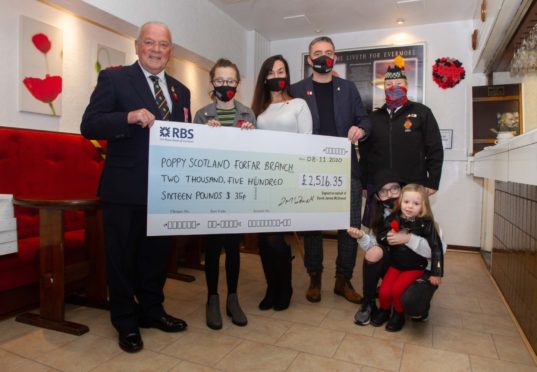 Legion Scotland National Chairman Charlie Brown (left) and his wife Margaret Brown, Forfar Legion branch chairman and secretary(right) receiving the cheque from Kylie Long, David McDowall and children Amelia (14), Darcy (10) and Thea(3).