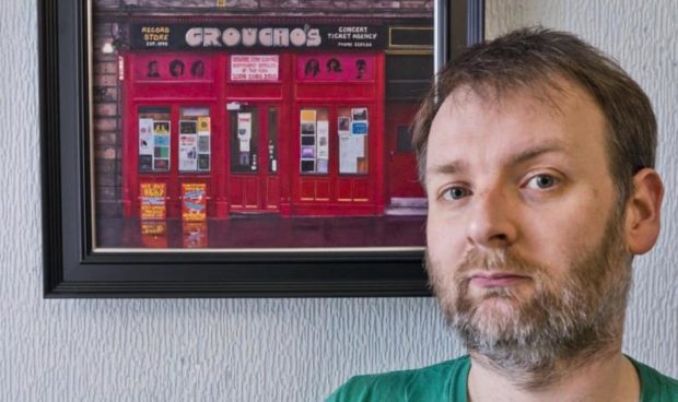 Alex Dewars with his painting of the iconic Dundee record store.