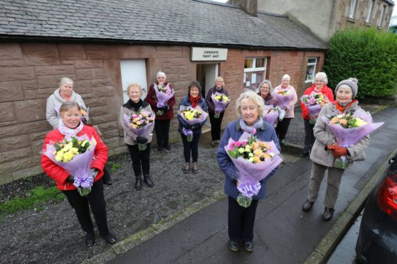 Manager Dorothy Vannet (front centre) with her fellow volunteers.