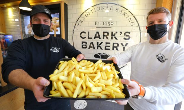 Clark‘s Bakery owner Jonathon Clark with operations manager Daniel Bunce and lots and lots of chips.