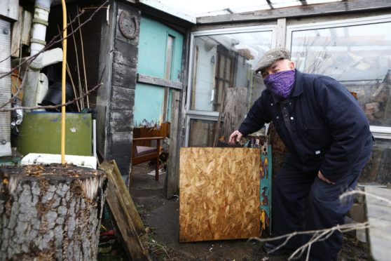 Martin Leiper, beside a damaged door, at one of the plots at the Old Craigie Road allotments in Dundee