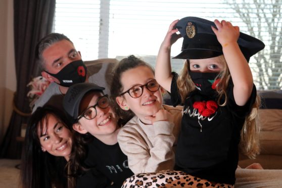 Forfar designer Kylie Long has created facemasks for remembrance day , with her partner David McDowall who served in the RAF , pictured stepdaughters Darcy (10) and Amelia (14) and daughter Thea (3)