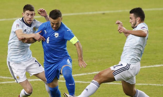 Israel's Bibras Natcho fights for the ball between Scotland's Ryan Christie and John McGinn.