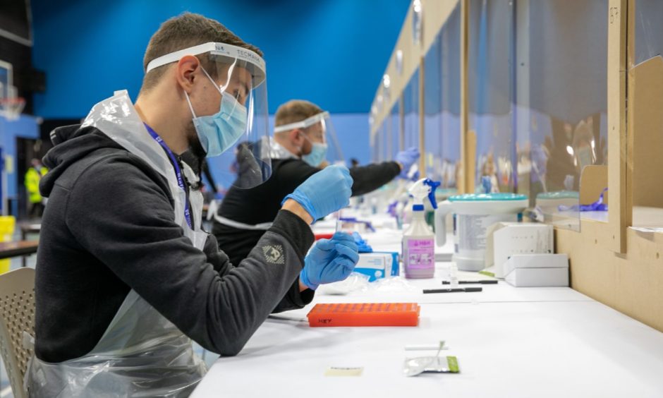 The centre in operation at Dundee University as testers prepare samples for results.