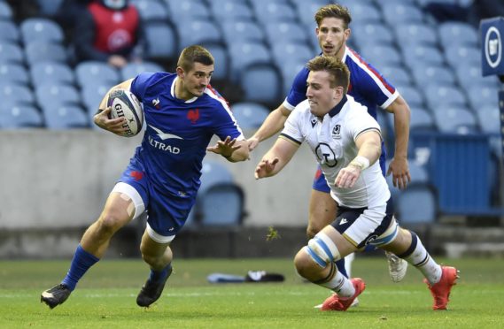 France's Thomas Ramos tries to escape Matt Fagerson at Murrayfield.