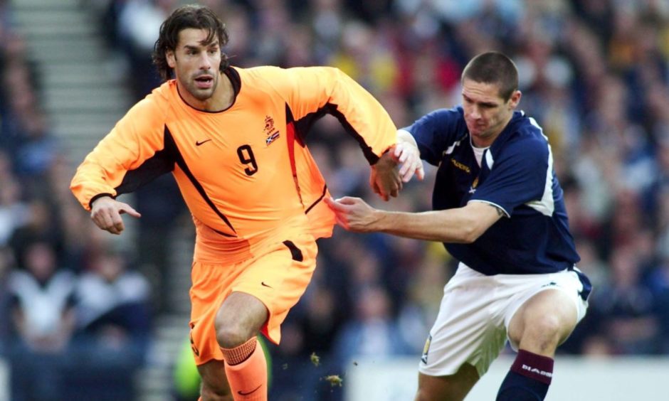 Lee Wilkie marks Ruud van Nistelrooy while playing for Scotland against Netherlands