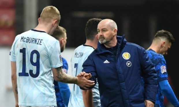 Steve Clarke and Oli McBurnie shake hands after the final whistle in Slovakia.