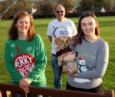 From left: Relay for life vice chairwoman, Margaret Craig, chairman Ian Angus and Megan Craig with dog Nala.
