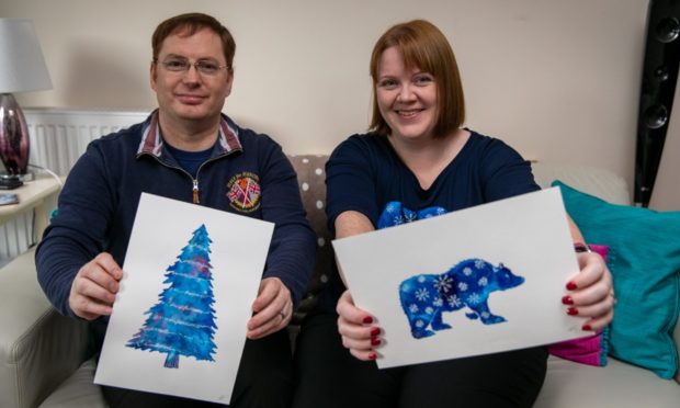 Julie Martin-Davy and her husband Mark with the designs chosen by the charity.