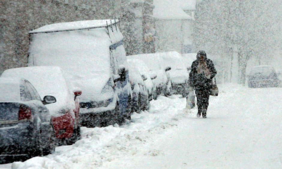 A woman struggling home from the shops in Stanley during the 2010 winter.