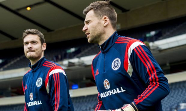 David Marshall is mobbed by his Scotland teammates after securing Scotland's place at Euro 2020.