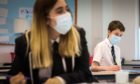 Pupils in chemistry lesson wearing their face masks.