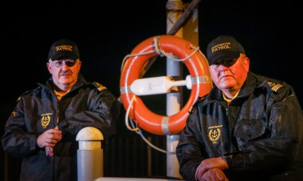 William Brown and Gareth Norman with one of the newly-replaced life rings at Broughty Ferry Harbour.