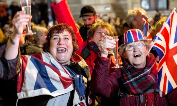 Brexiteers celebrate as they attend a gathering on Parliament Square in central London in celebration of the official moment the United Kingdom left the EU (January 2020).
