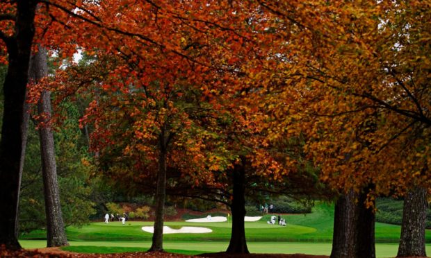 A view through the autumnal trees to the 12th green at Augusta.