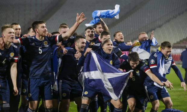 The Scotland team celebrates its win over Serbia and a place at Euro 2020.