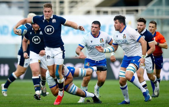 Duhan van Der Merwe leads the charge for Scotland against Italy.