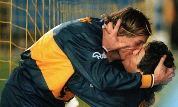 Claudio Caniggia and Diego Maradona celebrate a goal during their time together at Boca Juniors.