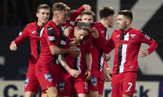 Dunfermline striker Declan McManus (centre) is mobbed by team-mates after netting the equaliser at Dens Park.