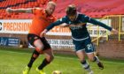 Dundee United defender Mark Connolly challenges Motherwell striker Callum Lang.