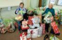 Betty Mathieson (left) and Liz Howson at St Andrews Church Hall in Brechin with some of the angel tree appeal gifts.