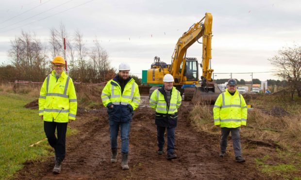 Steven Reid SSE Renewables;, Scott McCreadie, project manager Nexans; Angus Council leader Councillor David Fairweather; Maurice Dee, one of the workers on the cable installation team from contractor, Roadbridge.