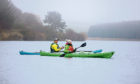 Gayle Ritchie and Piotr Gudan of Outdoor Explore paddling on Backwater Reservoir in Angus.