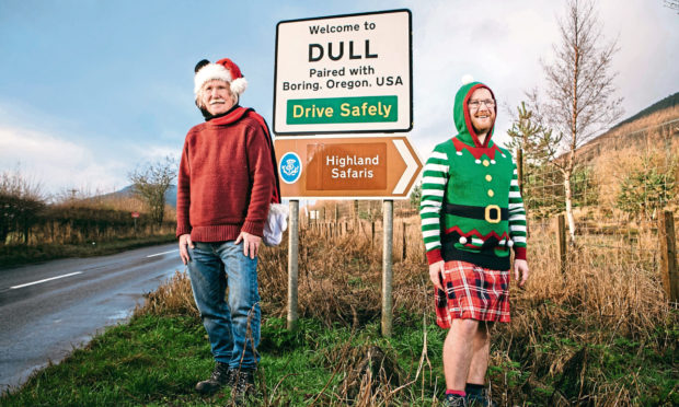 Tommy Pringle with his son, Jamie Pringle, beside the sign of Dull, their hometown near Aberfeldy.