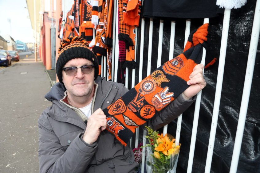 Jed Hepburn, 58, ties his scarf on the gate.