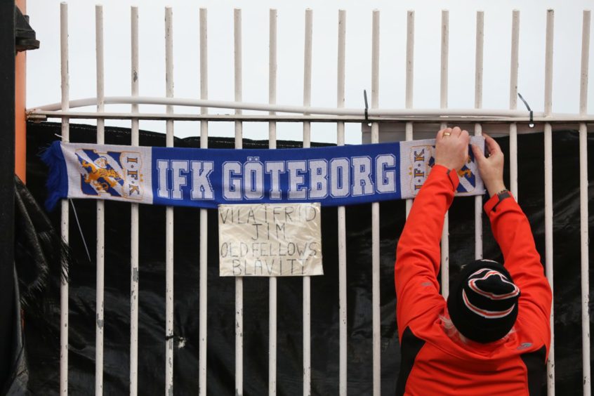 A Gothenburg scarf is put up by one fan.