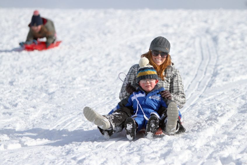 Susan and Sam Trueland sledging near Balmossie Road. Thursday on March 1 2018.