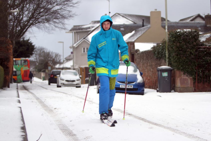 Angus Sangster uses telemark skis to get around the streets of Carnoustie during the snow storms in March, 2018.