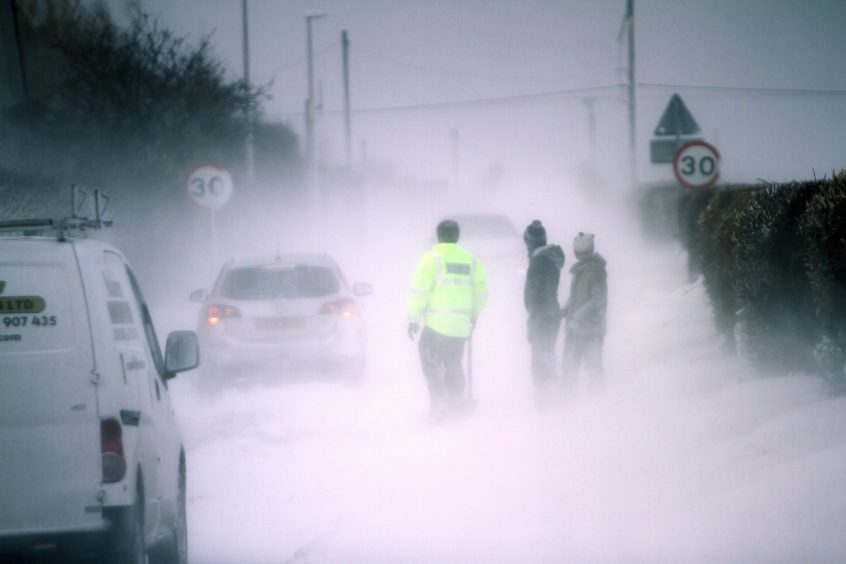 Good Samaritans dig drivers out of snow drifts on the Panbride Road in Carnoustie on Thursday,  March 1, 2018.