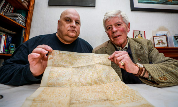 Historian Lenny Low and Jamie Lindsay with the sasine document from 1593 relating to Jamies family