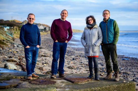 Largo Arts directors Dougi McMillan and Andrew Stenson with Carol and Andy Duff on the beach at Lower Largo. Image credit dougimcmillanphotography.com.