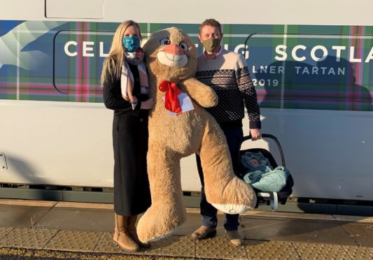 Dr Emily Barker, Major Tim Barker and their 10-week-old daughter Thea with Evelyn's bear.